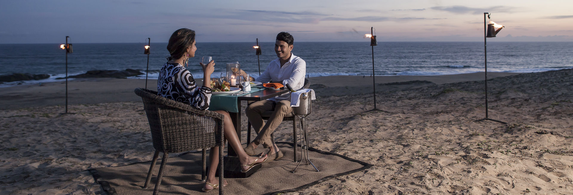 couple having a signature dining experience on the beach